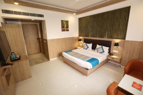 a bedroom with a large bed in a room at Hotel Elevate Suites Near Delhi Airport WITH- Free Airport PICKUP in New Delhi