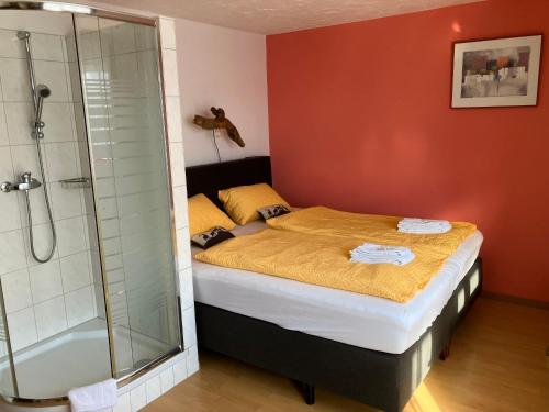 a bedroom with a bed and a shower at Gasthaus Morgenrot in Embd