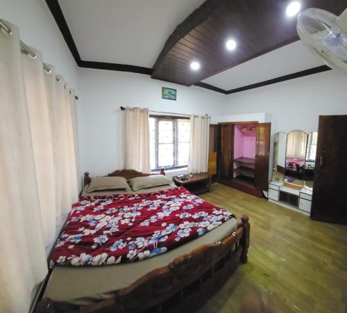 a bedroom with a large bed in a room at Mysticgreens Home Stay in Piriyāpatna
