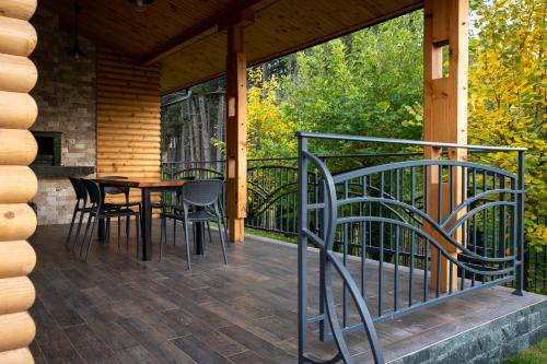a screened in porch with a table and chairs on it at SPA Hotel Infinity Park Velingrad in Velingrad