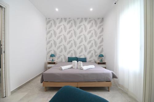 a bedroom with a bed and two blue chairs at Residenze Miao in Montalto di Castro
