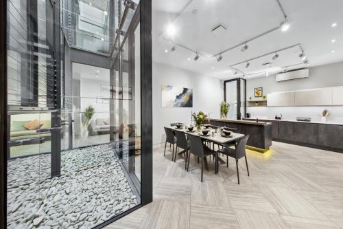 a dining room with a table and chairs at The Chelsea Villa in London