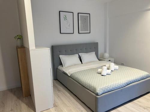 a bedroom with a bed with three candles on it at Best Value Studio Primavara, Free Parking in Bucharest