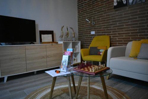 a living room with a couch and a tv at Casa da Vila in Campo Maior