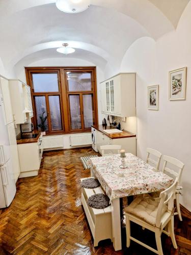 a kitchen and dining room with a table and chairs at Marina Old Town Apartment with 1 free parking offsite in Košice