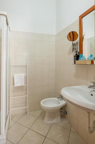 a white bathroom with a sink and a toilet at Girasole room Sperlongaresort in Sperlonga