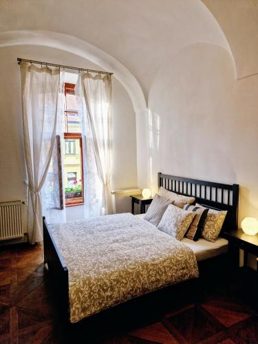 a bedroom with a large bed and a window at Marina Old Town Apartment with 1 free parking offsite in Košice