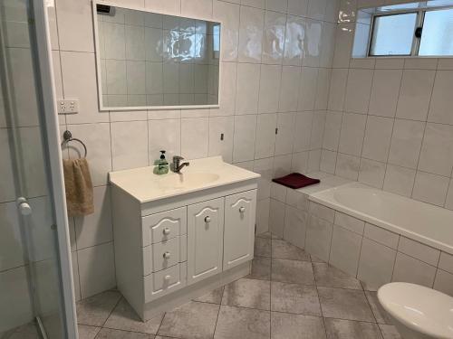 a bathroom with a sink and a tub and a toilet at Beachside & Jetty View Apartment 6 - Captain's Apt in Streaky Bay