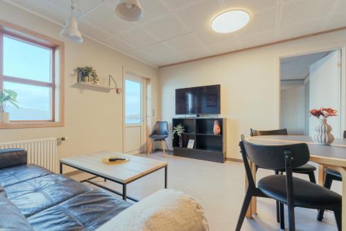 a living room with a couch and a table at Á Tromini Guesthouse in Tórshavn
