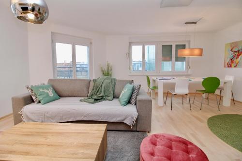 a living room with a couch and a table at Graz central Penthouse Style Apt in Graz