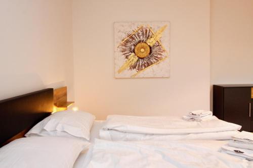 a bedroom with a bed and a picture on the wall at Graz central Penthouse Style Apt in Graz