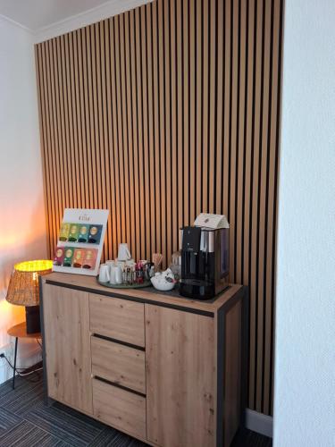 a room with a counter with a microwave on it at Hotel Am Schwarzen Berg in Stade