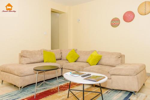 a living room with a couch and a table at Nimmoh's Homestays at Kishan Towers in Nanyuki