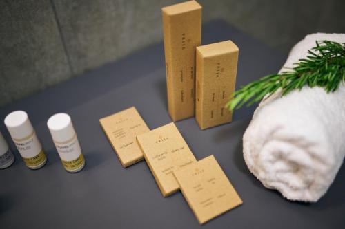 a table with two bottles of essential oils and a plant at Arancini Residence in Vodice
