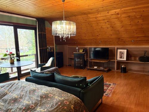 a living room with a couch and a television at Efes home in Ghent