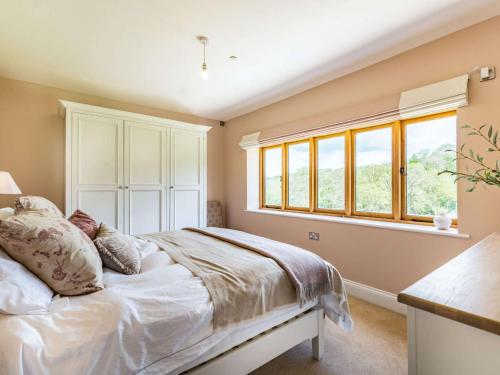 a bedroom with a bed and a window at 4 Bed in Chirk 87675 in Chirk