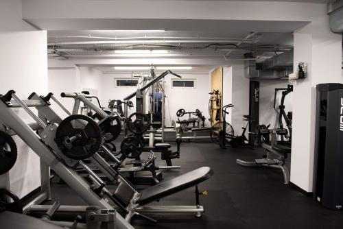 a gym with several treadmills and machines at City Apartments Protos in Knurów