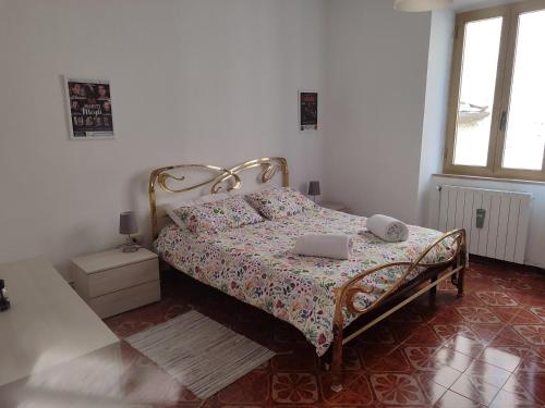 a bedroom with a bed with two laptops on it at Appartamento Isabella in Pistoia