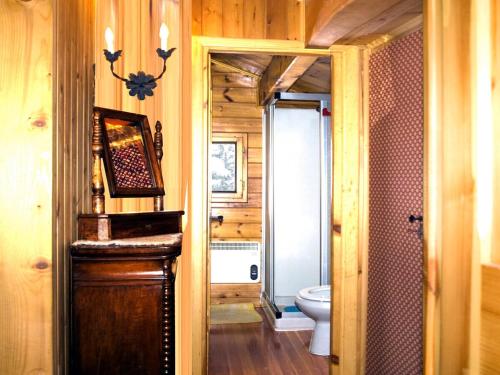 a bathroom with a toilet and a sink at Chalet Tradizionale con bel giardino in Champoluc