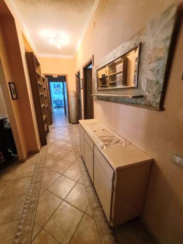 a kitchen with an open refrigerator in a hallway at Casa vacanze zona mare in Quartu SantʼElena