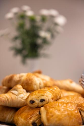 a pile of pastries sitting on top of a table at Good Morning+ Nyköping in Nyköping