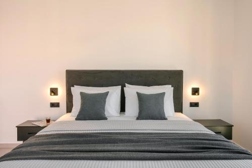 a bedroom with a large bed with four pillows at Villa Theoni in Asos