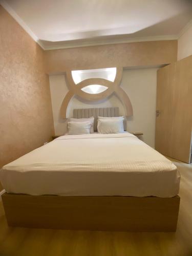a bedroom with a large white bed with a window at CC Luxurious Apartment in Hurghada