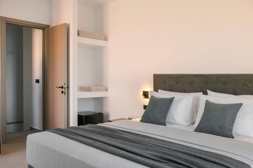 a bedroom with a large bed with white pillows at Villa Theoni in Asos