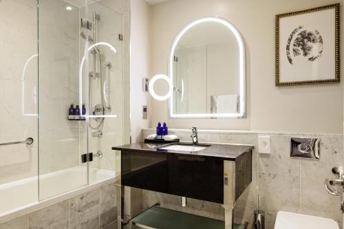 a bathroom with a sink and a shower at The Caledonian Edinburgh, Curio Collection by Hilton in Edinburgh