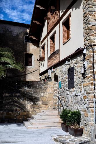 a stone building with stairs in front of it at Katrapona in Getaria