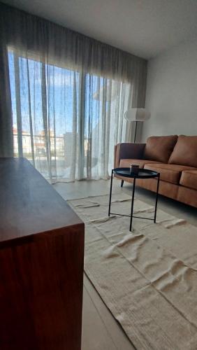 a living room with a couch and a coffee table at One bedroom apartment in Paphos City