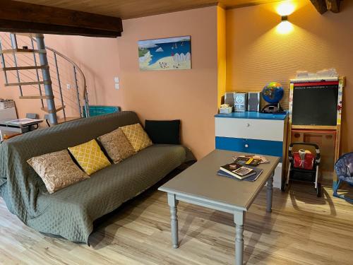 un salon avec un canapé et une table dans l'établissement La Maison Majorelle, à Bar-sur-Aube