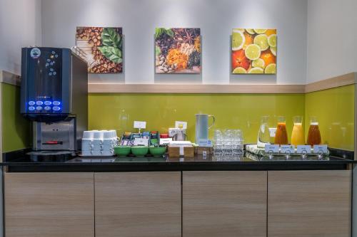 a kitchen with a counter with a coffee maker and drinks at Good Morning+ Nyköping in Nyköping