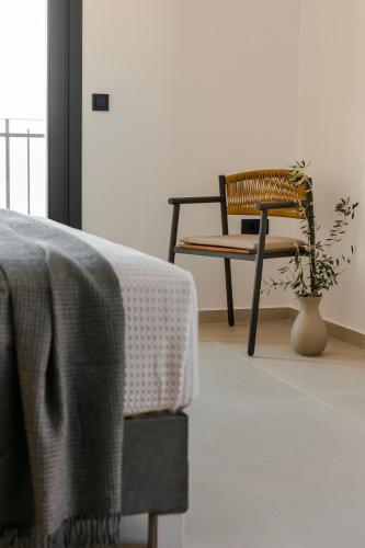a chair and a table and a plant in a room at Villa Theoni in Asos