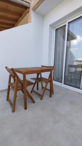 a wooden table and a bench on a balcony at One bedroom apartment in Paphos City