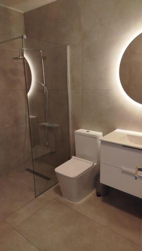 a bathroom with a shower and a toilet and a sink at One bedroom apartment in Paphos City