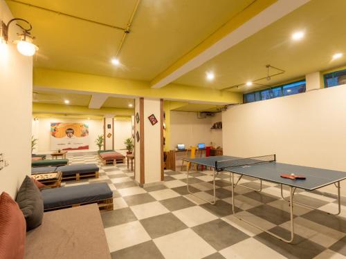 a living room with a ping pong table in it at Moustache Delhi in New Delhi