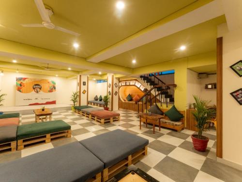 a living room with couches and a staircase in a room at Moustache Delhi in New Delhi