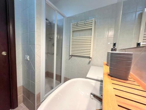 a bathroom with a shower and a bath tub at Appartamento Tramonto su Roma in Tivoli