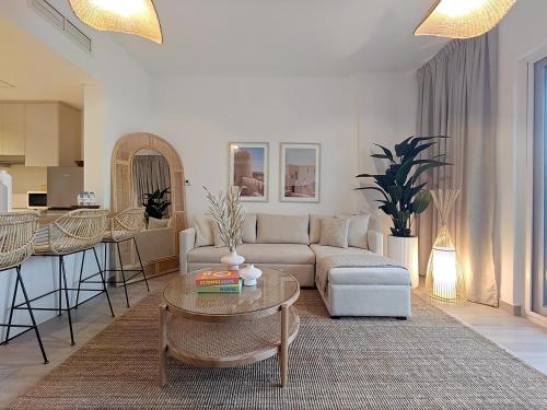 a living room with a couch and a table at Otolo Homes with Free Yas Theme Park Tickets in Abu Dhabi