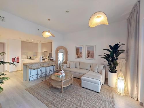 a living room with a couch and a table at Otolo Homes with Free Yas Theme Park Tickets in Abu Dhabi