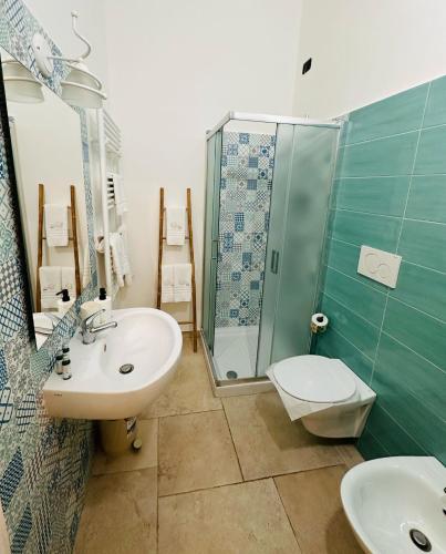 a bathroom with a sink and a shower at Grace Home in Tricase