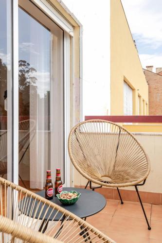 a chair and a bowl of food on a balcony at Seaside Urban Retreat – 5min to Esposende Beach in Esposende