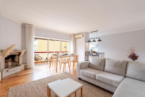 a living room with a couch and a table at Seaside Urban Retreat – 5min to Esposende Beach in Esposende