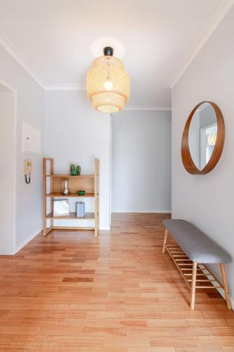 a living room with a chair and a mirror at Seaside Urban Retreat – 5min to Esposende Beach in Esposende