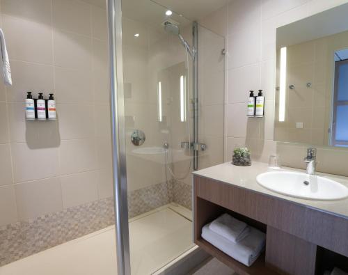 a bathroom with a shower and a sink at Pullman Bordeaux Lac in Bordeaux