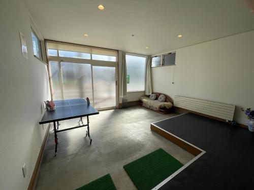a living room with a table and a couch at Hakodate cozy house w/parking in Hakodate