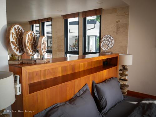 a living room with a couch and plates on the wall at Infinity villa 600 M2 sea view in Haad Yao
