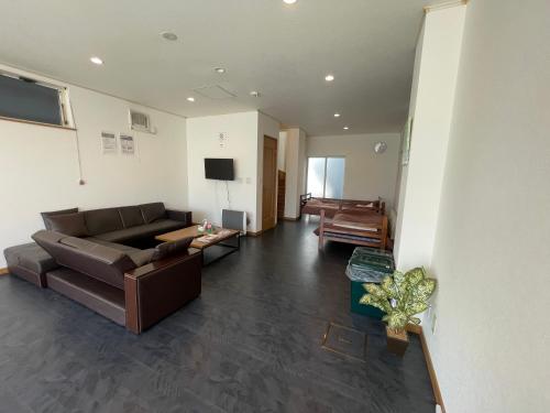 a living room with a couch and a tv at Hakodate cozy house w/parking in Hakodate