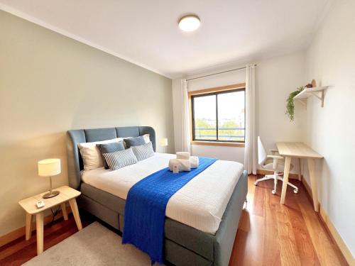 a small bedroom with a bed and a window at Albufeira Modern 7 With Pool by Homing in Albufeira